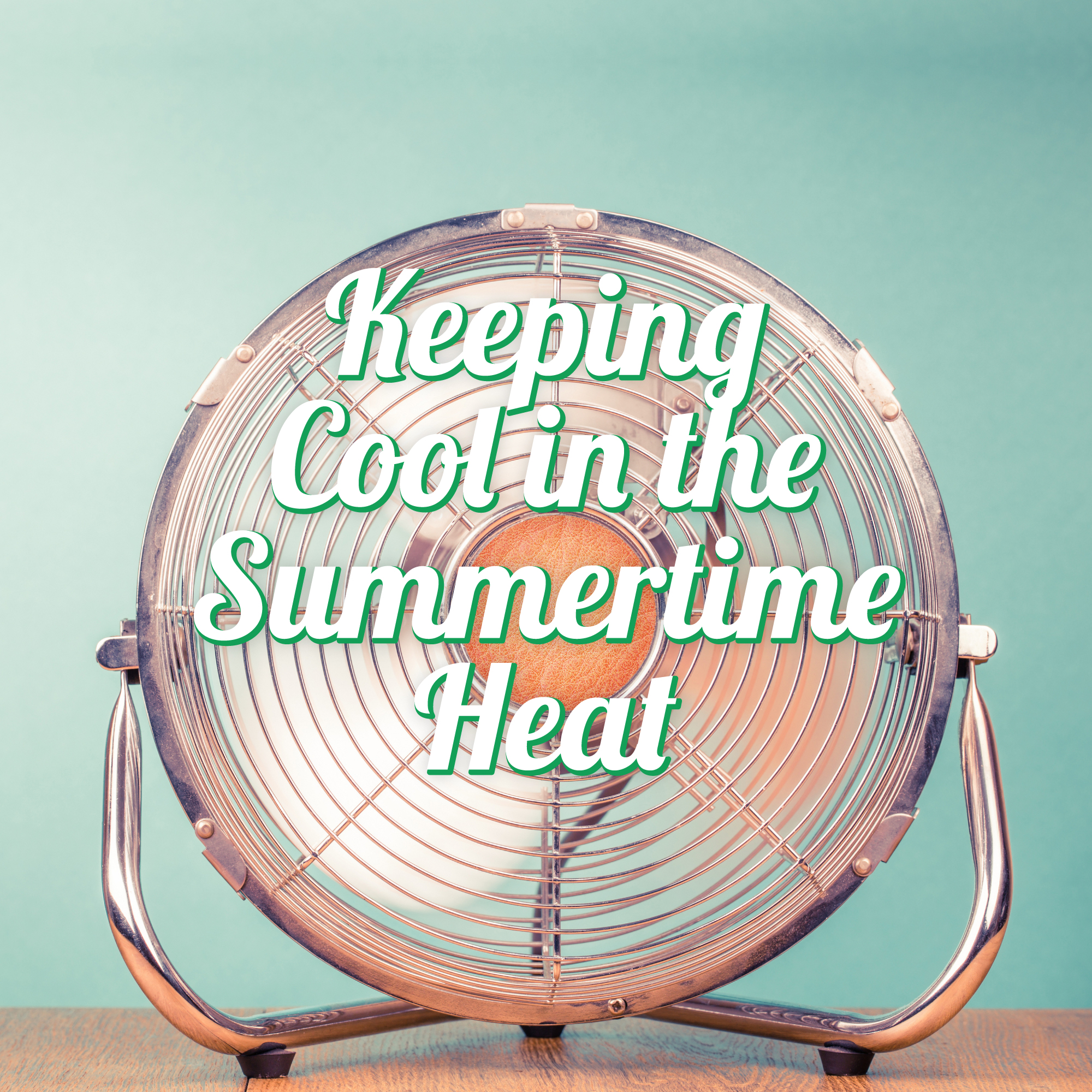 A metal fan sits on a wooden surface against a teal background, with the text "Keeping Cool in the Summertime Heat" overlaid in white and green letters.