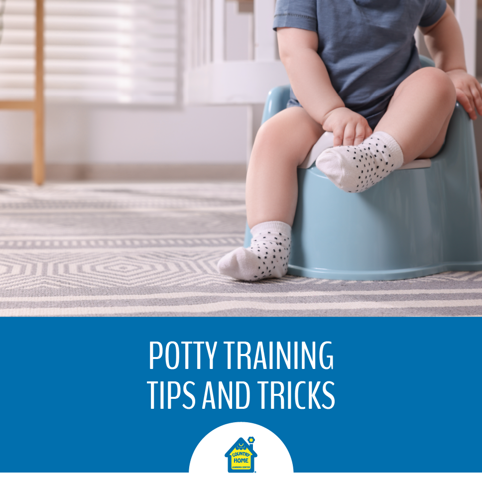 toddler being potty trained with a potty chair