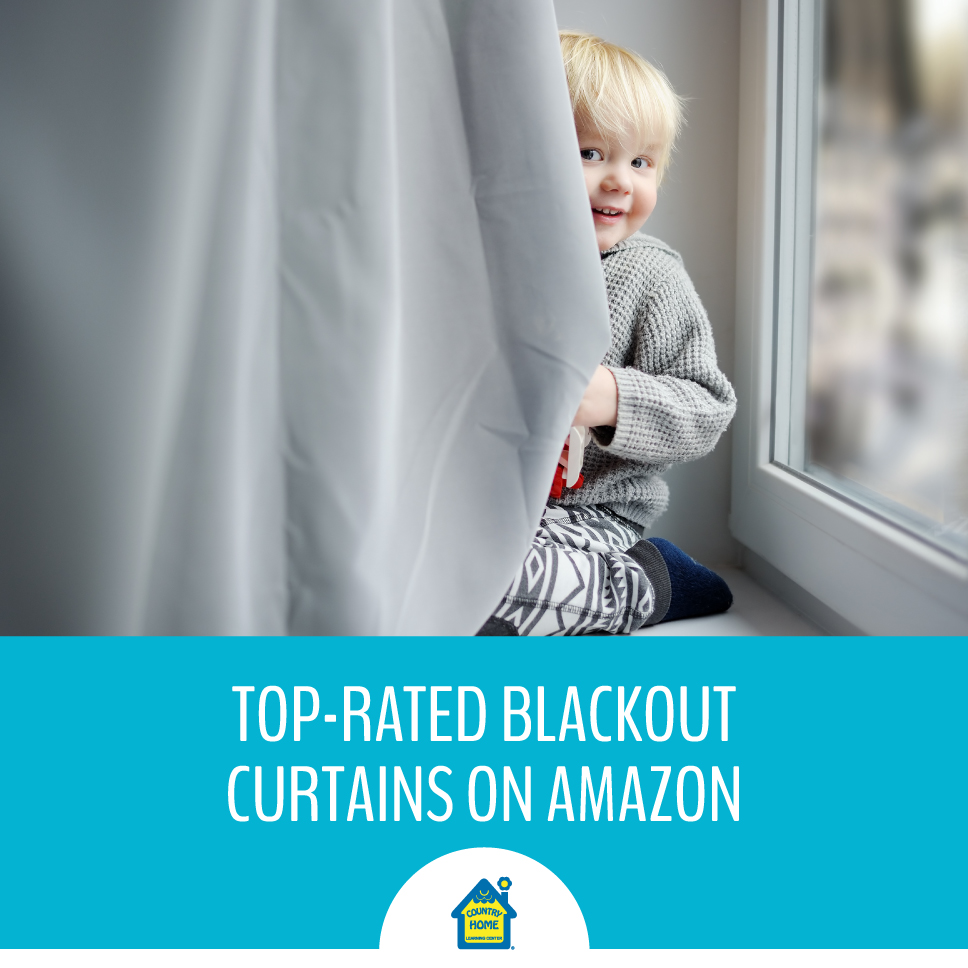 little boy in winter pajamas playing peek-a-boo with curtains