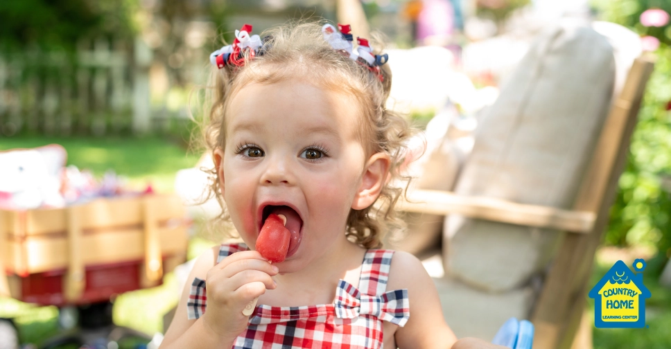 young girl eating a popsicle