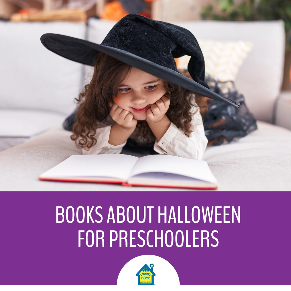 preschool girl reading a halloween book while dressed up in a halloween costume