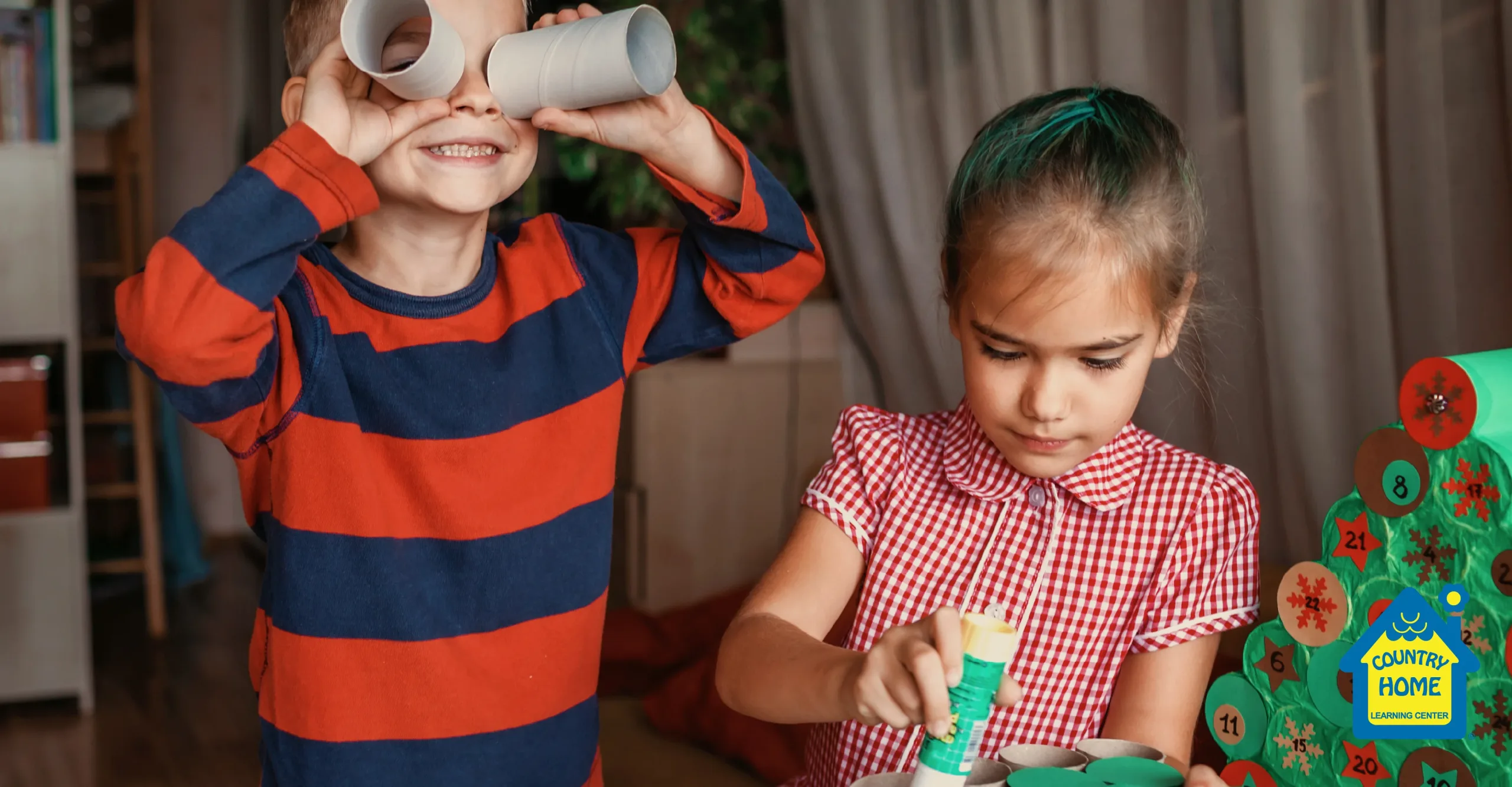 brother and sister happily and playfully craft a christmas advent calendar out of cardboard tubes for the holiday season