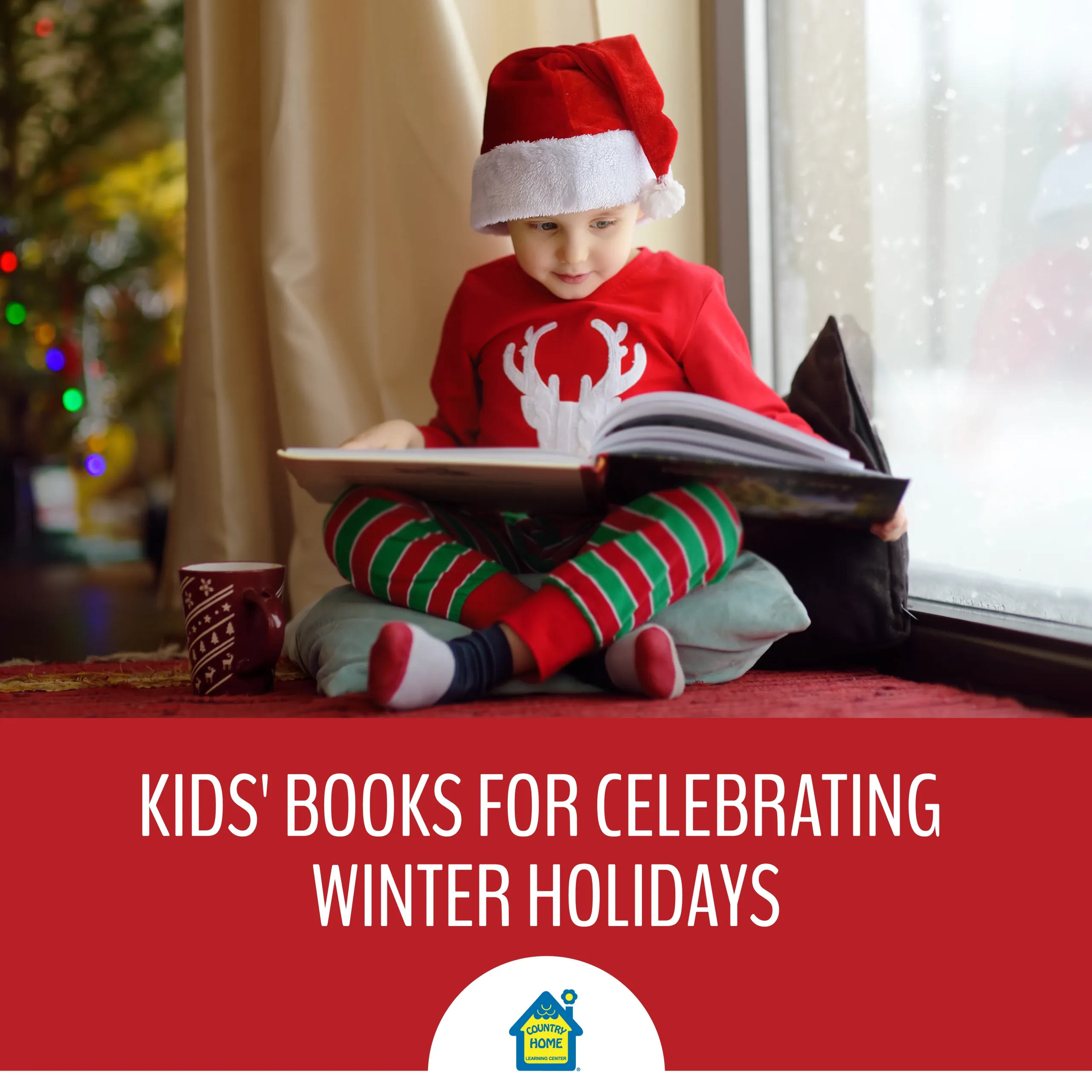a young boy wearing christmas pajamas and santa hand reads a holiday book next to the christmas tree as it snows outside.