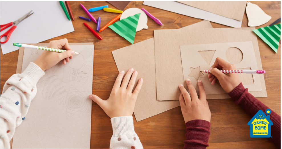 two sets of children's hands drawing and cutting out paper
