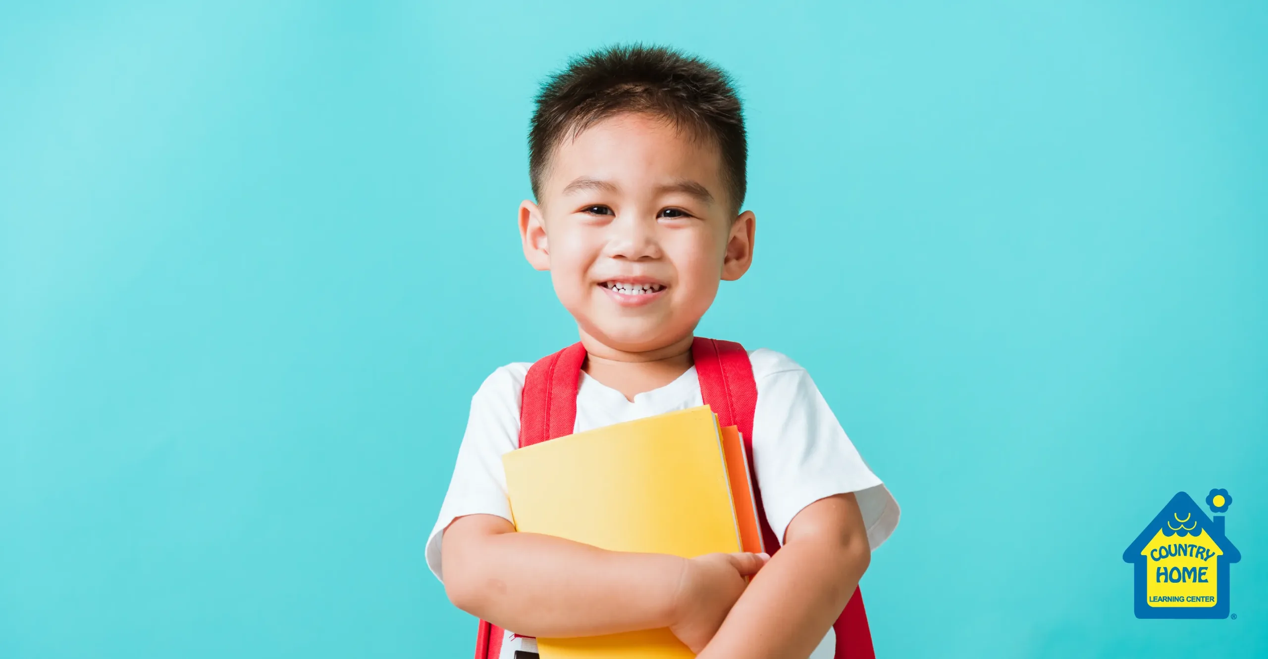 Young kindergarten child with a red backpack smiles and holds a yellow folder against a bright blue background. Country Home Learning Center logo is in the bottom right corner.