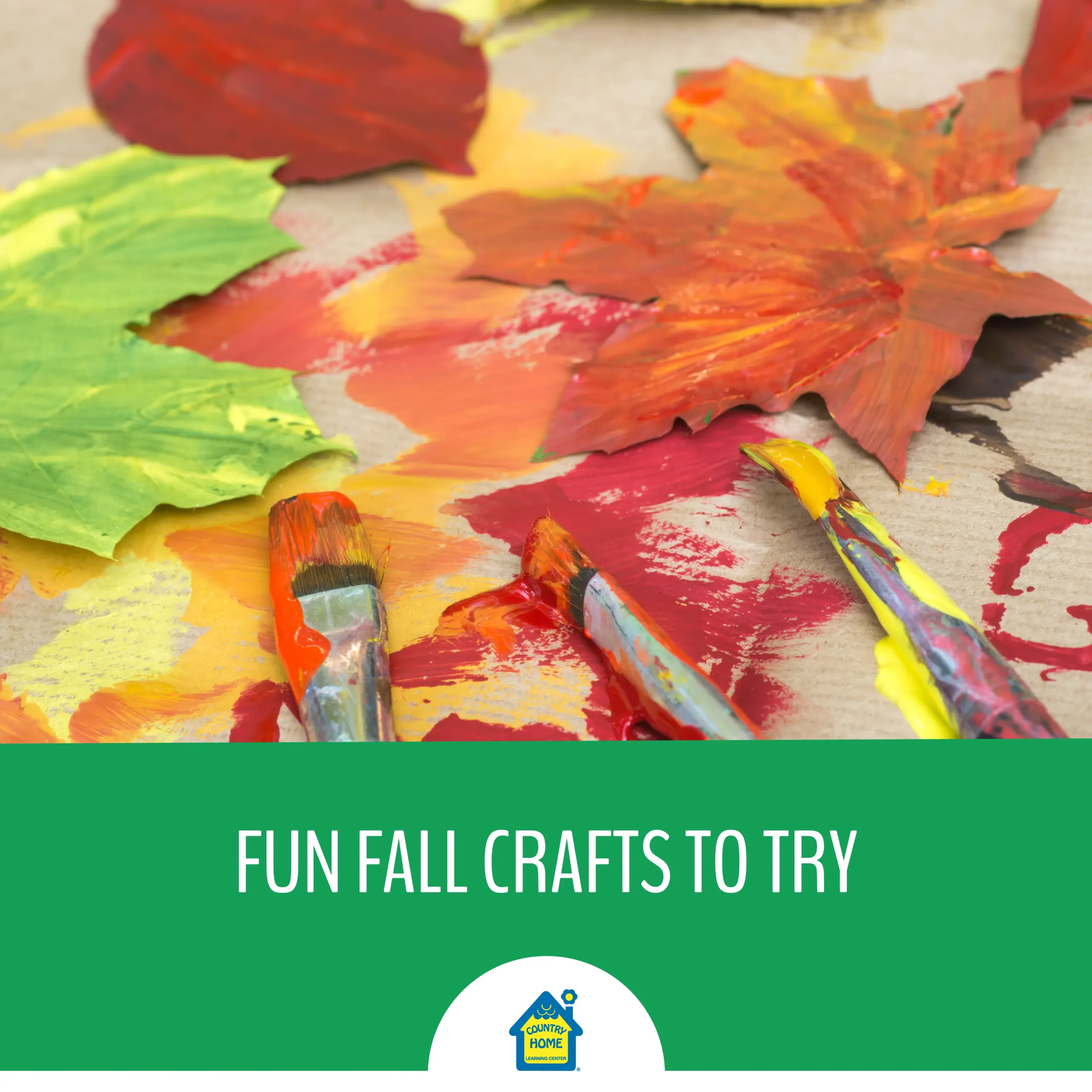 Close-up of autumn craft project with painted leaves and brushes covered in bright fall colors