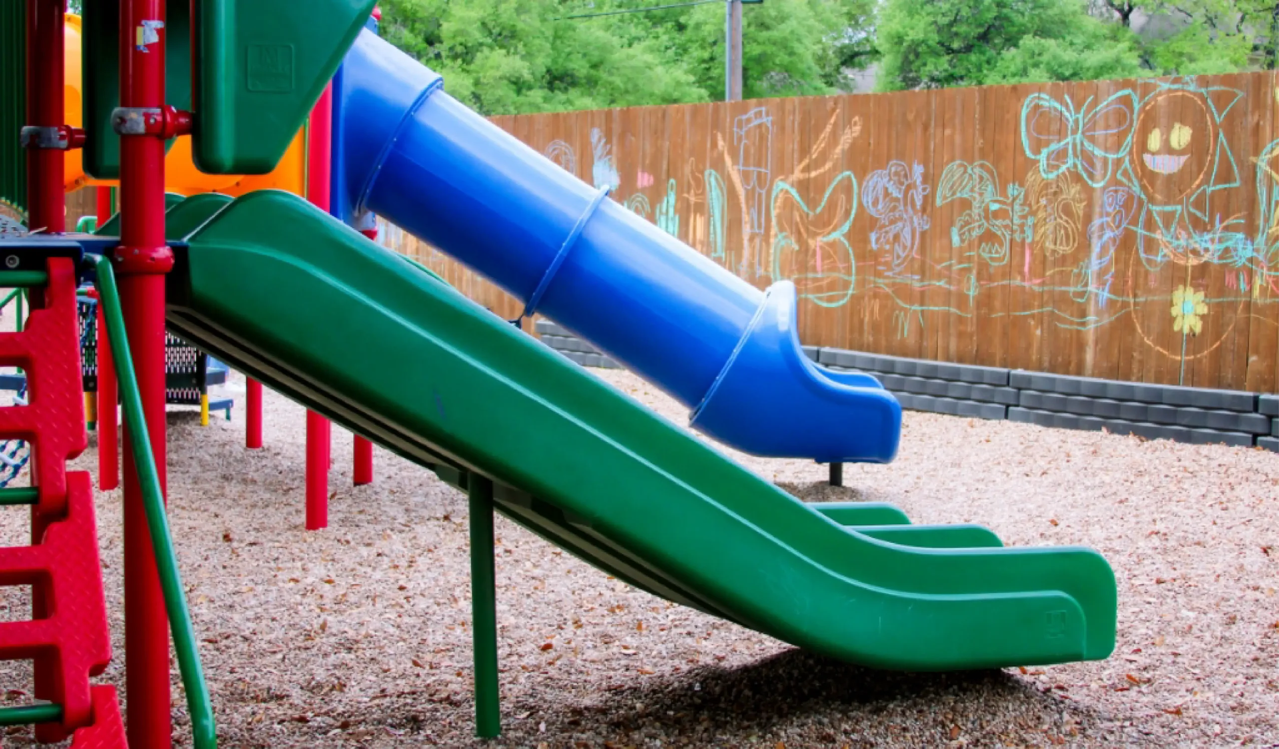 blue and green slides on a daycare playground