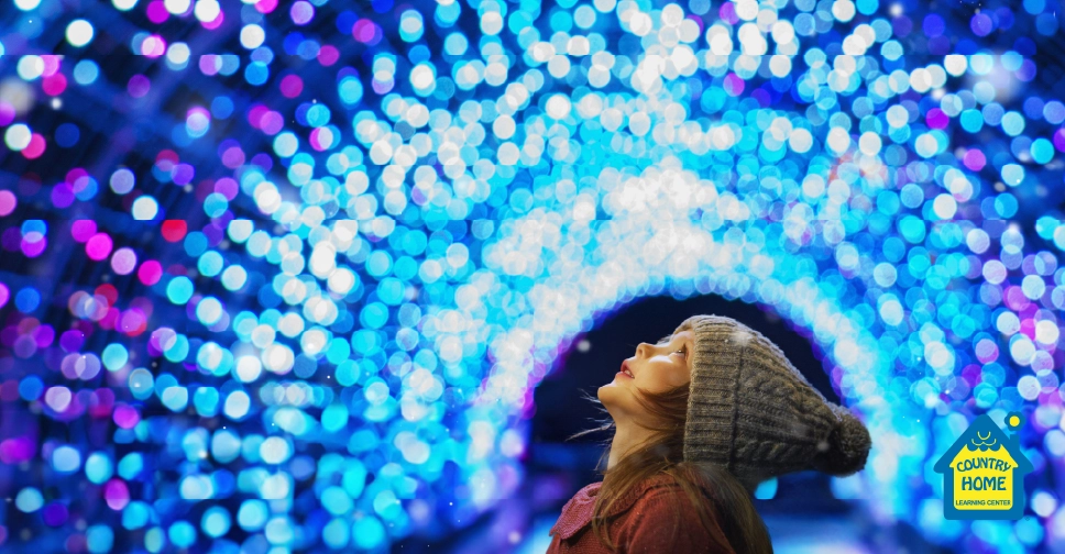 A girl looking at beautiful lights during Christmastime.