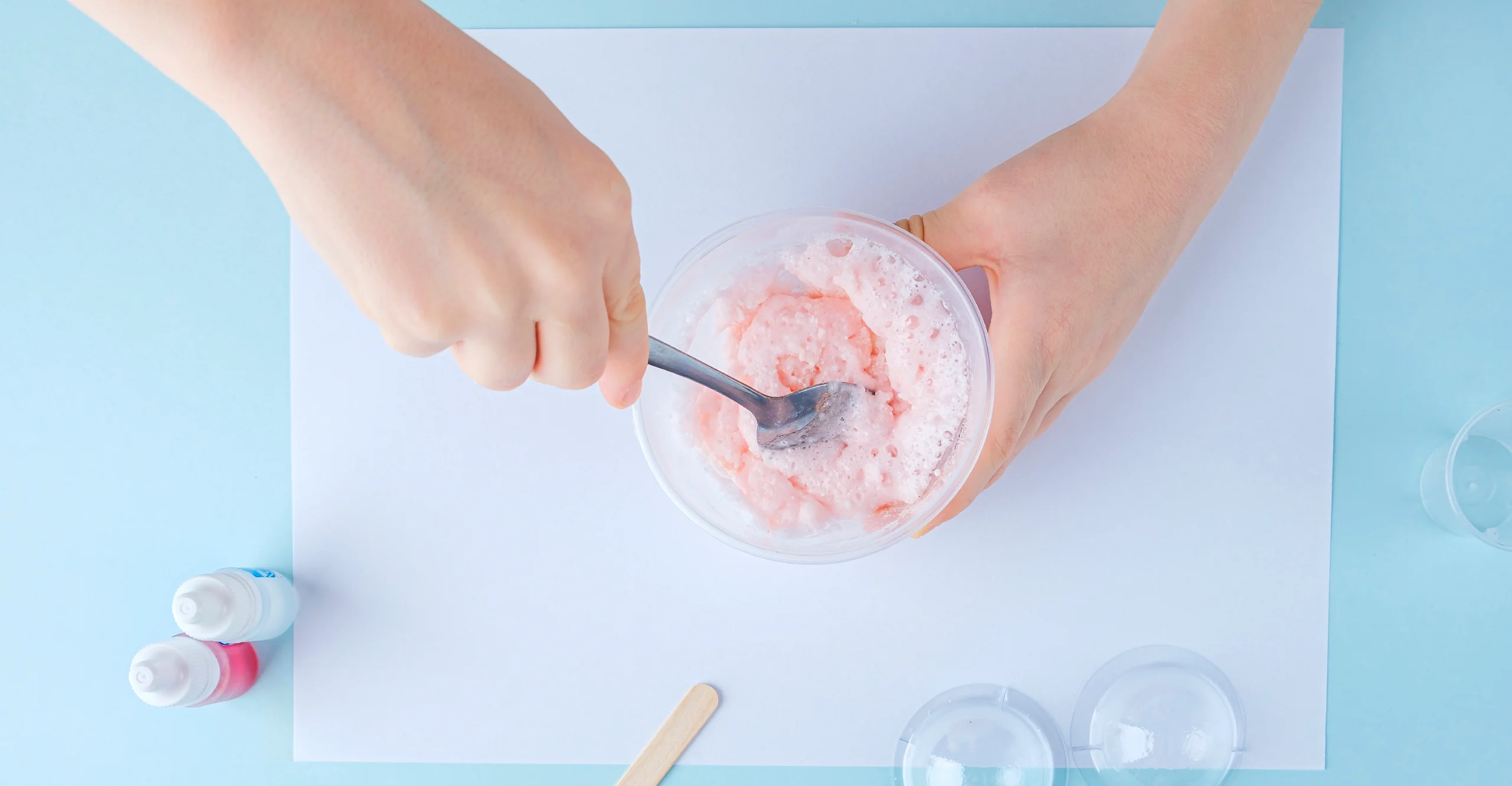 A person mixes ingredients together, making homemade bath salts.