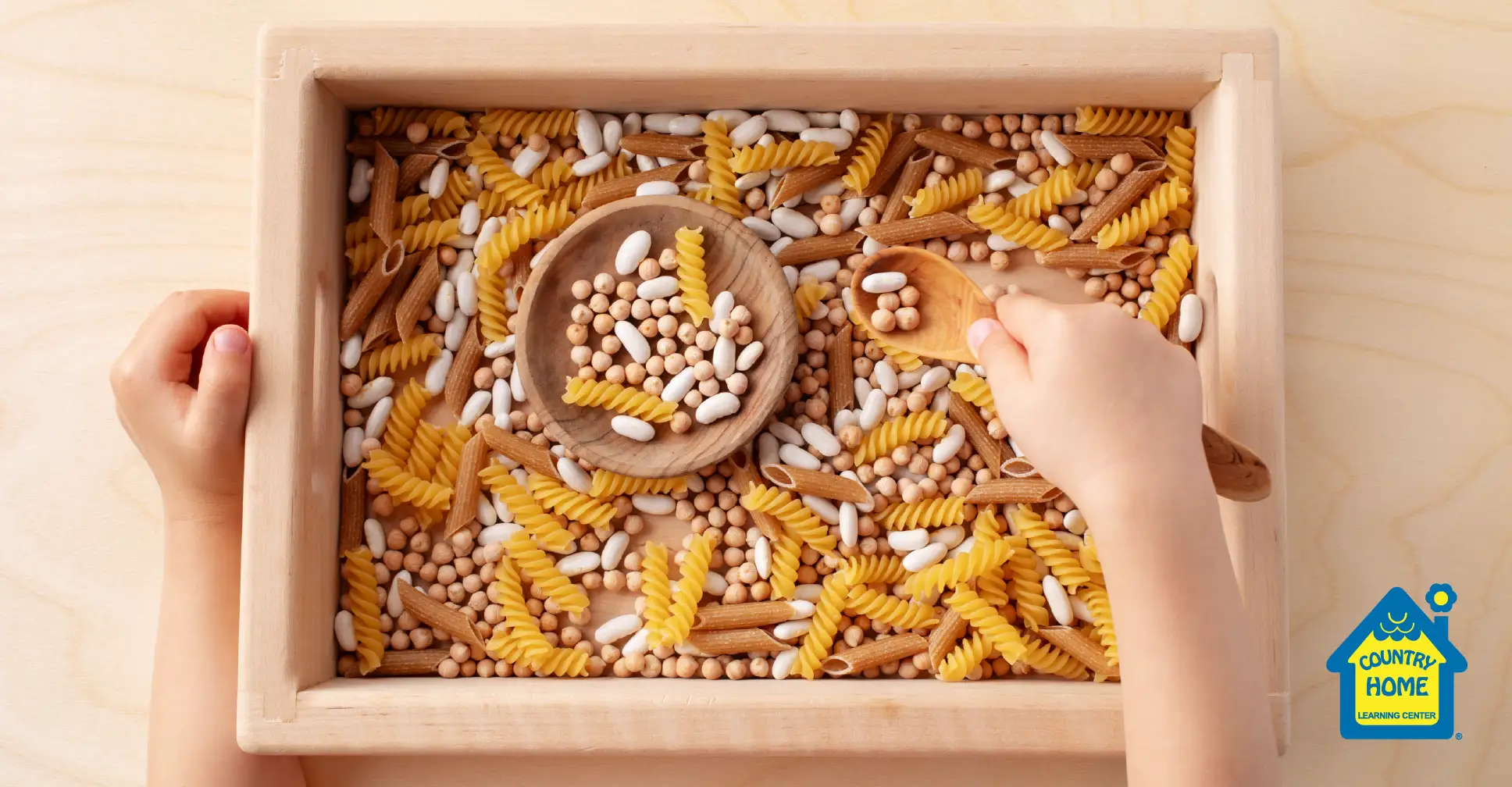 Indoor activity with rice and pasta sensory bin.