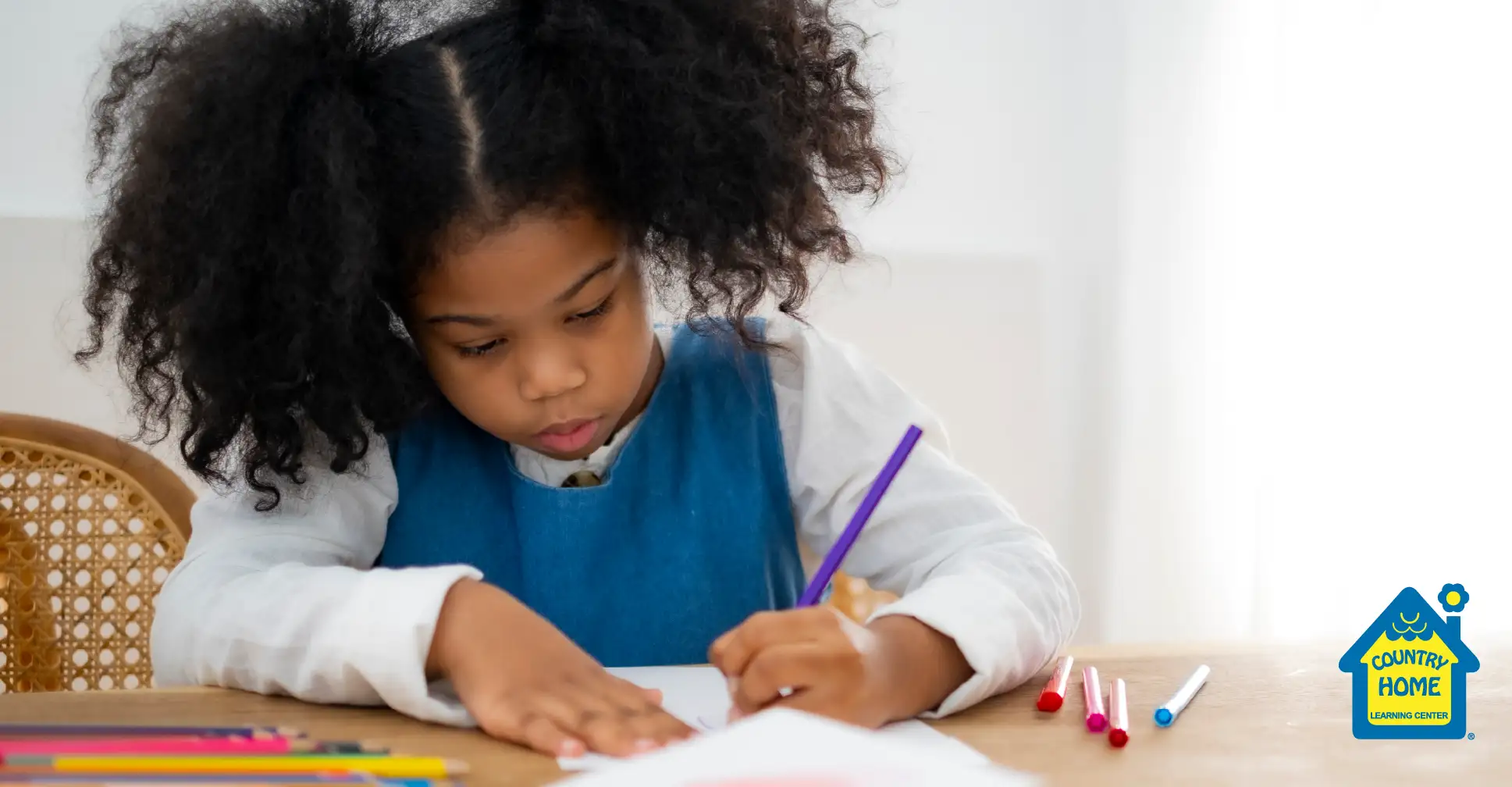 Little girl making a card for Mother's Day.
