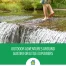 A kid walking in a creek with bare feet.