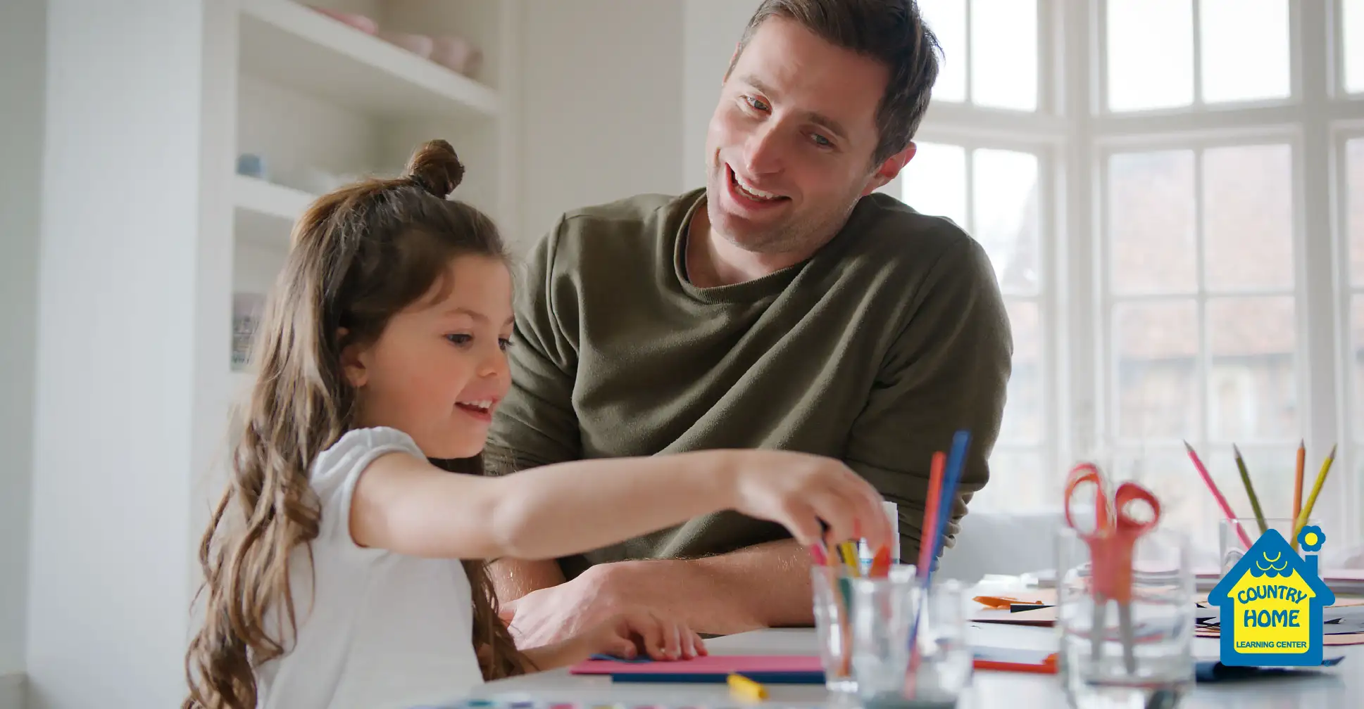 Dad and daughter working on arts and crafts.
