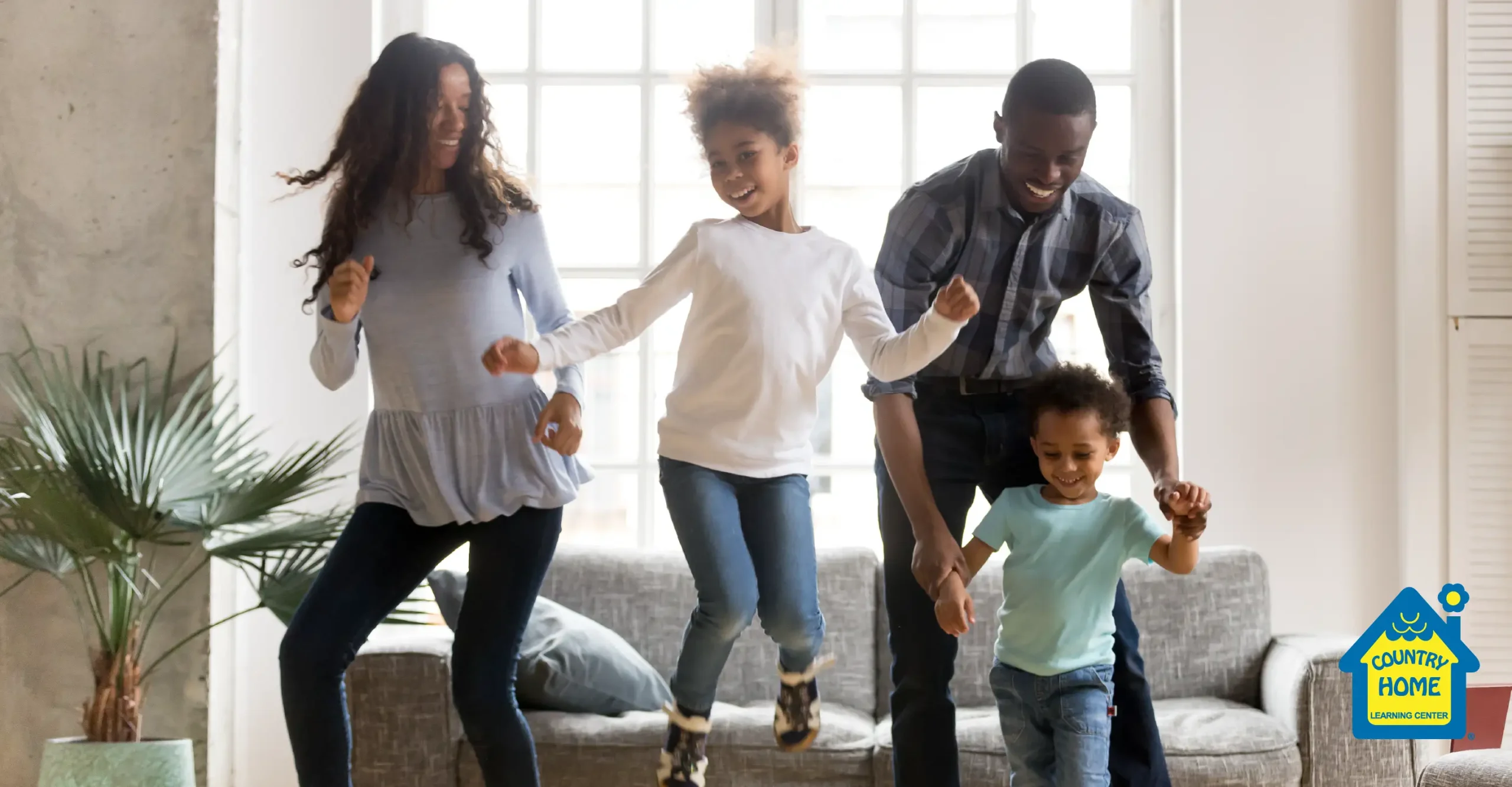 Kids dancing with their parents at home.