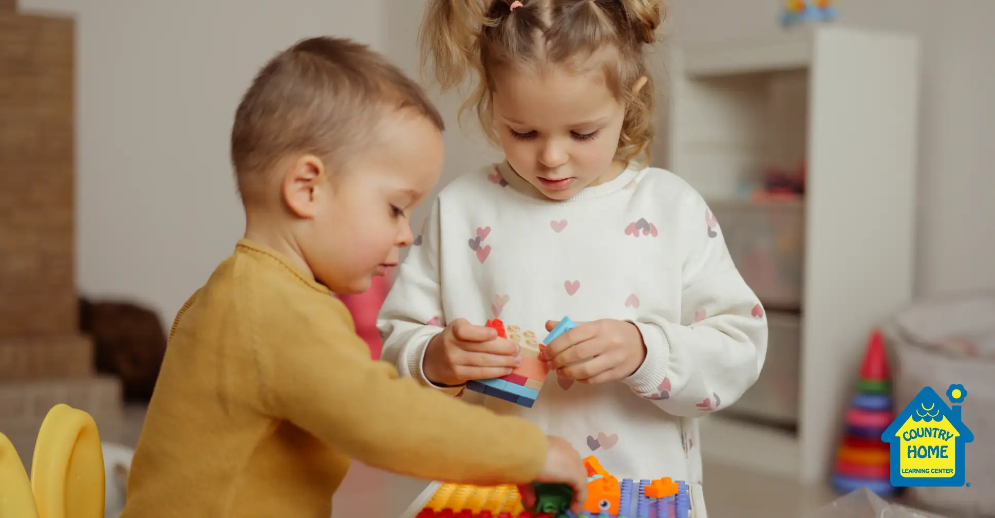 A boy and a girl playing with Legos at preschool.