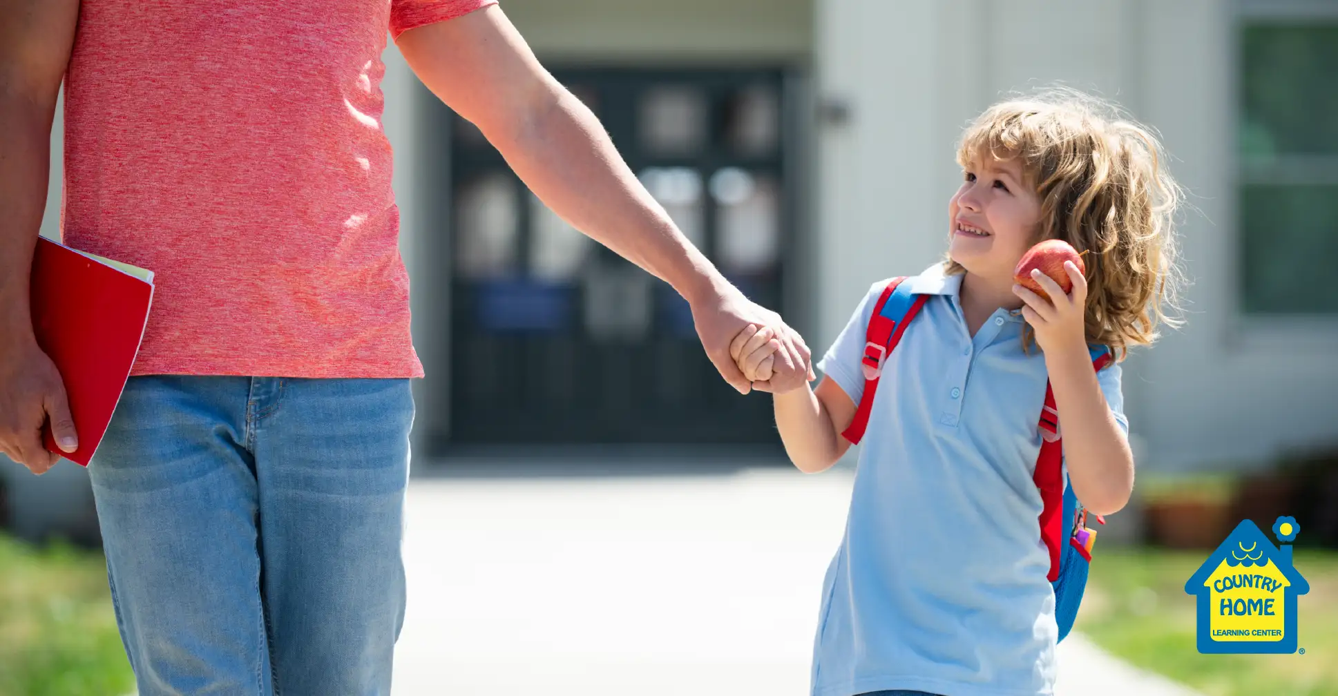 A dad walking his child into school.